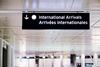 International,Arrivals,Sign,Board,In,English,And,French,At,Airport