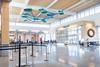 Columbia Regional Airport terminal interior with modern design, check-in area, passengers and contemporary ceiling installation enhancing passenger experience