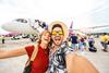 Happy,Couple,Of,Tourists,Boarding,On,A,Plane,At,The
