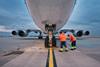 Low,Angle,View,Of,Freight,Airplane.,Ground,Staff,At,Airport.