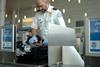 A,Tsa,Agent,Searches,Luggage,At,An,Airport.,(12mp,Camera,