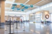 Columbia Regional Airport terminal interior with modern design, check-in area, passengers and contemporary ceiling installation enhancing passenger experience