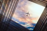 Jet,Plane,Plying,In,Business,District,Area,,Office,Buildings,