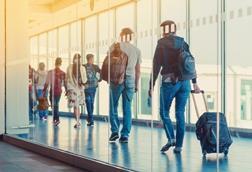 Back,View,Of,Passengers,And,Traveling,Luggage,Walking,The,Airplane