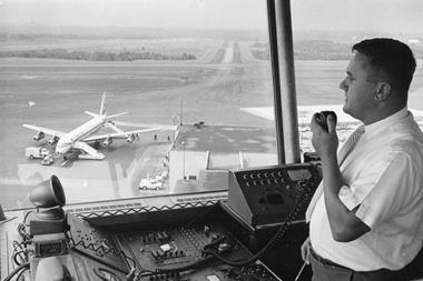 A Federal Aviation Agency (FAA) Air Traffic Controller guides a plane to a safe landing, 1965.