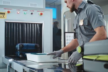 Airport,Security,Checkpoint:,Security,Officer,Putting,Suitcases,And,Personal,Items