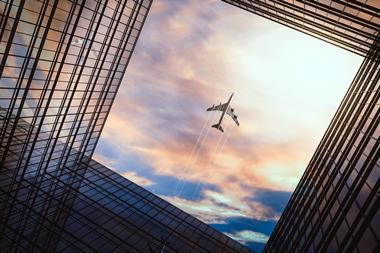 Jet,Plane,Plying,In,Business,District,Area,,Office,Buildings,