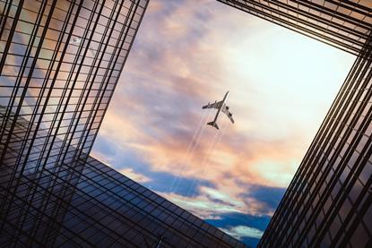 Jet,Plane,Plying,In,Business,District,Area,,Office,Buildings,