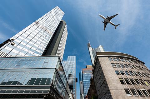 Frankfurt,Skyscrapers,Buildings,And,A,Plane,Flying,Overhead,In,Morning