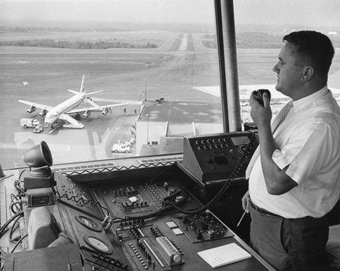 A Federal Aviation Agency (FAA) Air Traffic Controller guides a plane to a safe landing, 1965.