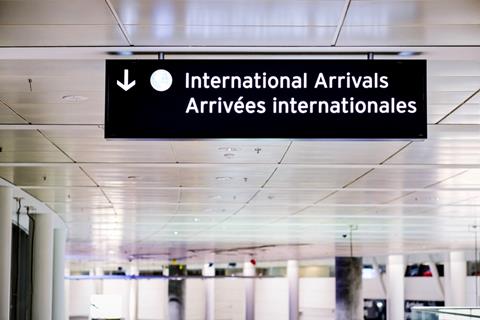 International,Arrivals,Sign,Board,In,English,And,French,At,Airport