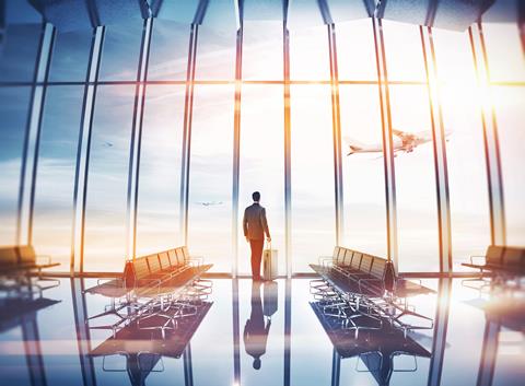 Businessman,At,Airport,With,Suitcase