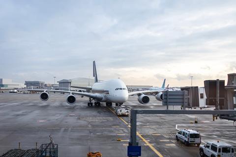 Large,4-engine,Passenger,Plane,Approaching,Jetway,At,London,Heathrow,Airport