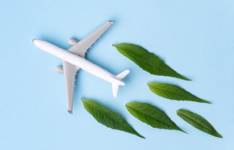 Sustainable,Aviation,Fuel.,White,Airplane,Model,,Fresh,Green,Leaves,On