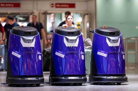 Heathrow airport cobots three purple cleaning robots