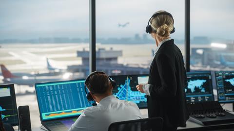 Female,And,Male,Air,Traffic,Controllers,With,Headsets,Talk,In