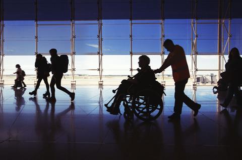 Silhouette,Of,Man,In,Wheelchair,And,People,Carrying,Luggage,And