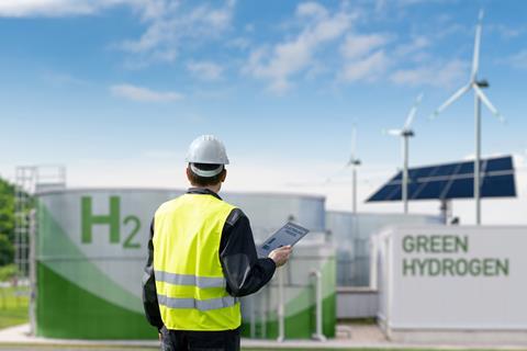 Engineer,With,Tablet,Computer,On,A,Background,Of,Green,Hydrogen