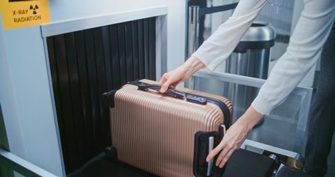 Security,Checkpoint,In,Airport,Terminal:,Passenger,Places,Suitcase,On,Conveyor