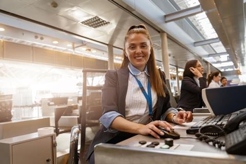 Woman,Airline,Employee,Working,At,Airline,Check,In,Counter,In