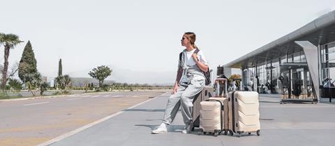 Young,Woman,Traveling,Solo.traveller,Alone,At,The,Airport,With,Suitcases,big